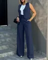 Full body shot of model wearing navy blue suit set in an elegant outdoor urban setting - Navy Blue