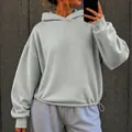 Close-up of oversized light grey hoodie featuring a drawstring hem and relaxed fit. - S / Tops / Light Gray