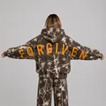 Back view of a camouflage oversized hoodie with orange Forgiven print and religious text - Dark Brown