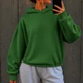 Detail view of an oversized forest green casual hoodie for women with adjustable hem - S / Tops / Green