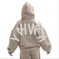 Back view of oversized tan hoodie featuring large white YHWH letter print detail - S / Tops / Khaki