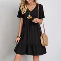 Casual black v-neck short sleeve mini dress with tiered ruffle hem and textured fabric - S / Top And Bottom / Black