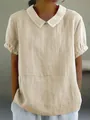 Close-up of women's beige loose linen-cotton shirt with white Peter Pan collar - S / Tops / Apricot