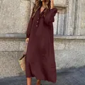 Outdoor street style view of a burgundy long-sleeved cotton linen maxi dress with buttons. - S / Tops / Burgundy