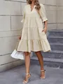 Elegant cream V-neck tiered dress with puff sleeves and pockets for a casual summer look. - Apricot