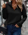 Detail showing the snake-bone texture and quarter-zip collar of the black sweatshirt - S / Tops / Black
