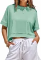 Detail view of mint green oversized crop top with chest pocket and raw edge hem. - Light Green
