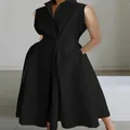 Close-up of elegant black sleeveless V-neck dress with a flared swing skirt design. - XS / Dresses / Black