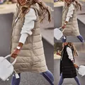 Detailed street style view of women's long hooded puffer vest in beige and black. - Apricot