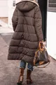 Back view of a stylish long brown hooded puffer coat for women in an urban outdoor setting - S / Tops / Coffee