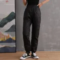 High-waisted black quilted down cotton pants with warm fleece lining and jogger cuffs. - M / Bottoms / Black