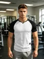 Men's slim fit white and black raglan sports t-shirt with v-neck in a gym setting - S / Tops / White Black Contrast