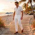 Men's white summer linen-style lace-up shirt and trousers set walking on a sunny beach path - S / Top And Bottom / White
