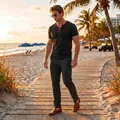 Macro view of men's black lace-up shirt and grey trousers on a tropical beach walk. - Black
