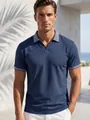 Close-up of navy blue men's polo shirt with geometric patterned collar and sleeve cuffs - S / Tops / Navy Blue