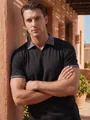 Model wearing a black men's casual polo shirt with patterned collar details - S / Tops / Black