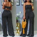 Front and back view of a chic black and white polka dot wide-leg jumpsuit with straps - S / Top And Bottom / Black