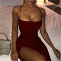 Close-up of a burgundy bodycon dress with spaghetti straps and high slit on a model - S / Tops / Burgundy