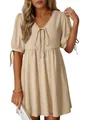 Detailed view of textured cream V-neck mini dress with puff sleeves and elegant bow tie front - S / Apricot
