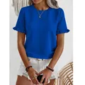 Detailed view of vibrant blue crew neck tee with textured fabric and ruffle sleeves. - S / Tops / Blue