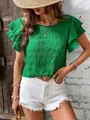 Detailed view of green smocked blouse with double ruffle sleeves and crew neck design. - L / Tops / Green