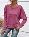 Close-up detail of a pink ribbed knit top featuring stylish batwing sleeves and a crew neck - Pink