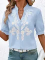 Detailed shot of a light blue cotton shirt featuring intricate white floral embroidery - S / Tops / Blue
