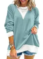 Close-up of women's waffle knit sweatshirt with teal and white color blocking - Light Green
