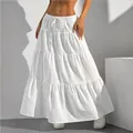 Close-up of a white tiered maxi skirt featuring a drawstring waist and textured fabric - S / Bottoms / White