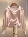 Detail of French style satin blouse featuring a pearl-embellished round neckline - S / Top (808145) / Apricot