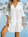 Woman wearing a loose white V-neck beach cover-up dress with ruffle details - S / White