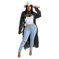 Detail view of a stylish black long fringe sweater paired with ripped jeans and a white hat - S / Tops / Black