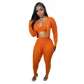 Detail view of orange handmade knit three-piece set with cardigan and leggings - S / Top And Bottom / Orange