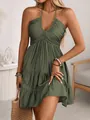 Detail view of olive green halter neck dress with tiered ruffle hem for summer fashion. - Olive Green