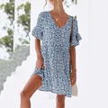 Detail of a blue floral summer dress featuring a V-neckline and feminine ruffle sleeves. - S / Blue Floral Print