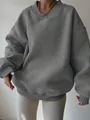 Detailed view of an oversized grey sweatshirt featuring a unique ribbed v-neck collar. - S / Tops / Gray