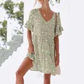Summer V-neck floral mini dress with ruffle sleeves shown in a bright lifestyle setting. - S / Apricot Print