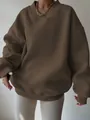 Close-up of women's oversized dark brown casual sweatshirt with ribbed v-neck detail. - S / Tops / Brown