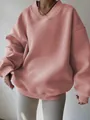 Detail of an oversized dusty pink sweatshirt with a crossover V-neck and ribbed cuffs. - Pink