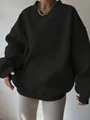 Detailed view of oversized black long-sleeve sweatshirt featuring V-ribbed neckline design - S / Tops / Black
