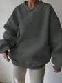 Detail view of an oversized dark grey V-neck sweatshirt for casual women's wear - Dark Gray