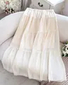 Macro view of a cream French style tiered maxi skirt featuring a delicate layered design - S / Milky White