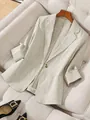 Detail view of a linen-textured light beige blazer for women with a single button - S / Tops / Champagne