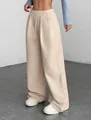 Detailed view of wide-leg corduroy pants with drawstring waist and textured fabric - S / Bottoms / Apricot