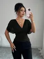 Mirror selfie showing the fit and style of a black deep V-neck flutter sleeve top - S / Tops / Black