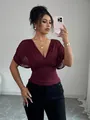 Close-up of elegant burgundy V-neck ruched top featuring a flattering slim waist fit design - S / Tops / Burgundy
