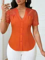 Macro view showing the pleated texture and lace embroidery on this orange blouse - Orange