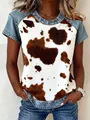 Close-up of casual women short sleeve top with cow print and denim stitching details - S / Tops / Cow Print