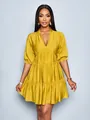 Detail of mustard yellow pleated mini dress with deep V-neck and puff sleeves - S / Bottoms / Yellow
