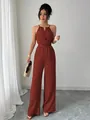 Elegant terracotta halter neck jumpsuit with wide leg silhouette and waist tie detail - S / Orange Red